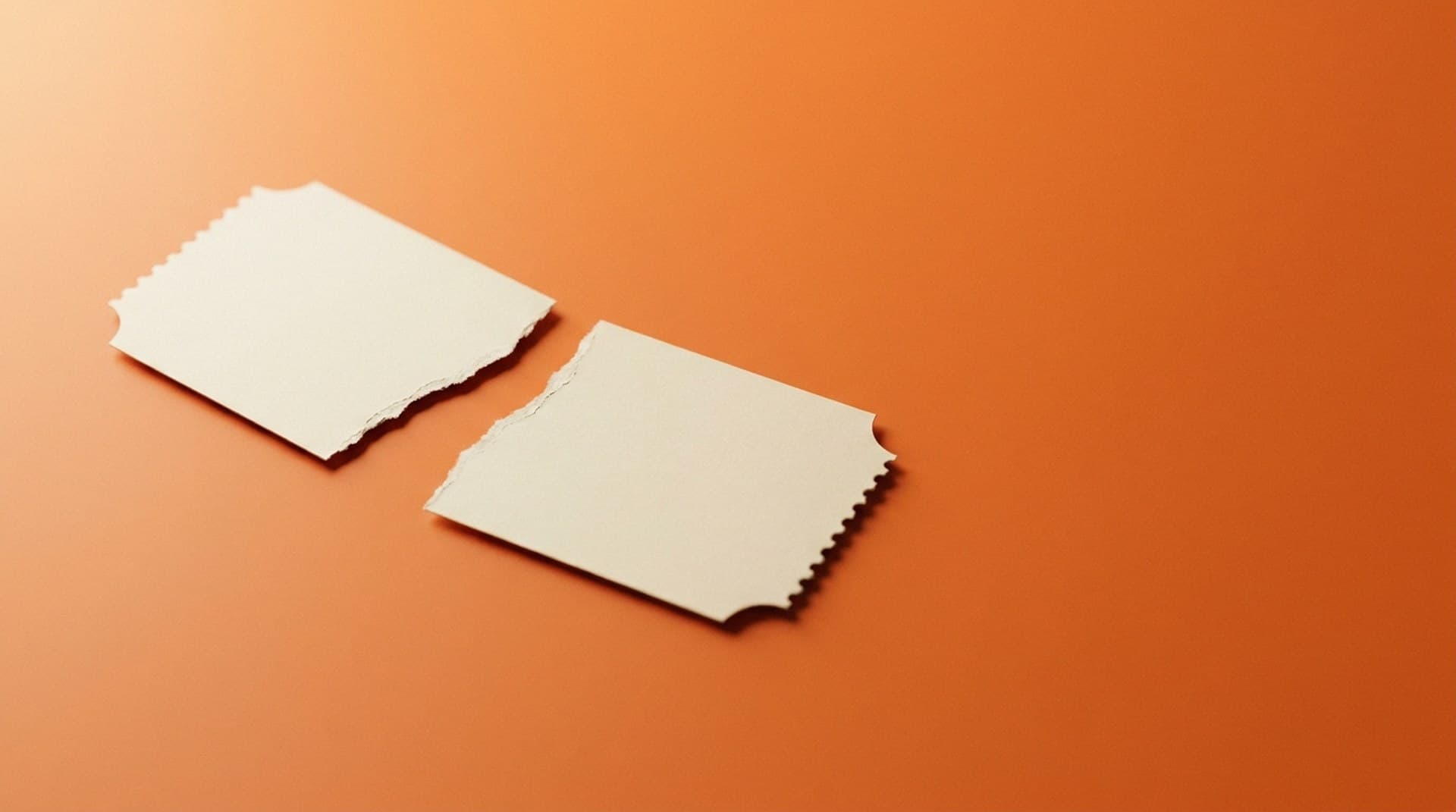 Enhanced conversions only work when both halves match. Two halves of a blank torn paper ticket stub on a tangerine-orange surface, their jagged edges matching, a metaphor for Google Ads enhanced conversions matching hashed lead data to a signed-in account